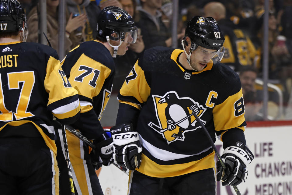 Pittsburgh Penguins' Evgeni Malkin (71) skates to the bench after scoring his second goal of the night, during the second period of the team's NHL hockey game against the Minnesota Wild in Pittsburgh, Tuesday, Jan. 14, 2020. Sidney Crosby had an assist on the goal, his second of the game. (AP Photo/Gene J. Puskar)