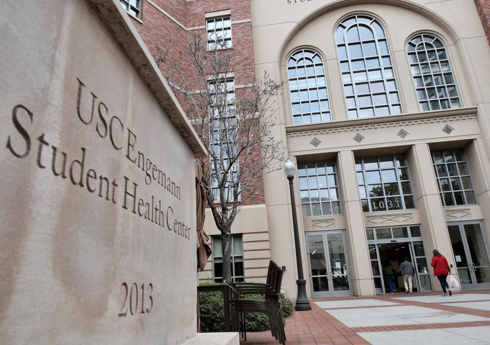 FILE - In this Tuesday, May 22, 2018, file photo, people enter the University of Southern California's Engemann Student Health Center in Los Angeles. Nearly 100 women who contend that they were sexually harassed or abused by a former University of Southern California gynecologist, Dr. George Tyndall, are suing the school, arguing it ignored decades of complaints. The filing of new lawsuits on behalf of 93 women against the university was announced Thursday, Oct. 18, 2018.