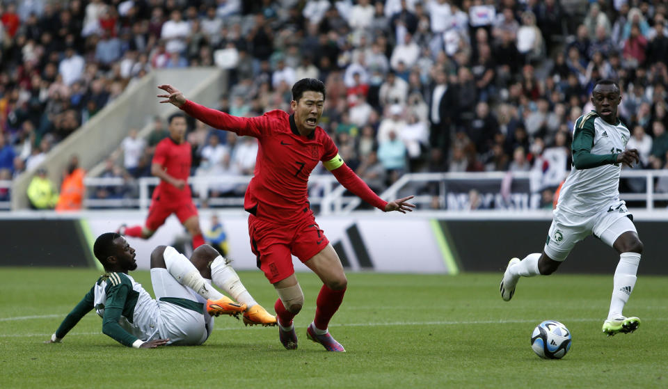 Saudi Arabia's Hassan Al Tambakti, left, and South Korea's Heung-min Son battle for the ball during their international friendly soccer match at St. James' Park, Newcastle upon Tyne, England, Tuesday, Sept. 12, 2023. (Will Matthews/PA via AP)