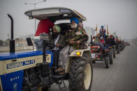 A retired soldier participates in a farmers tractor rally in a protest against new farm laws at Ghaziabad, outskirts of New Delhi, India, Thursday, Jan. 7, 2021. Indian farmers who have blockaded key highways for weeks say they'll continue their protests for new agricultural laws to be repealed. (AP Photo/Altaf Qadri)