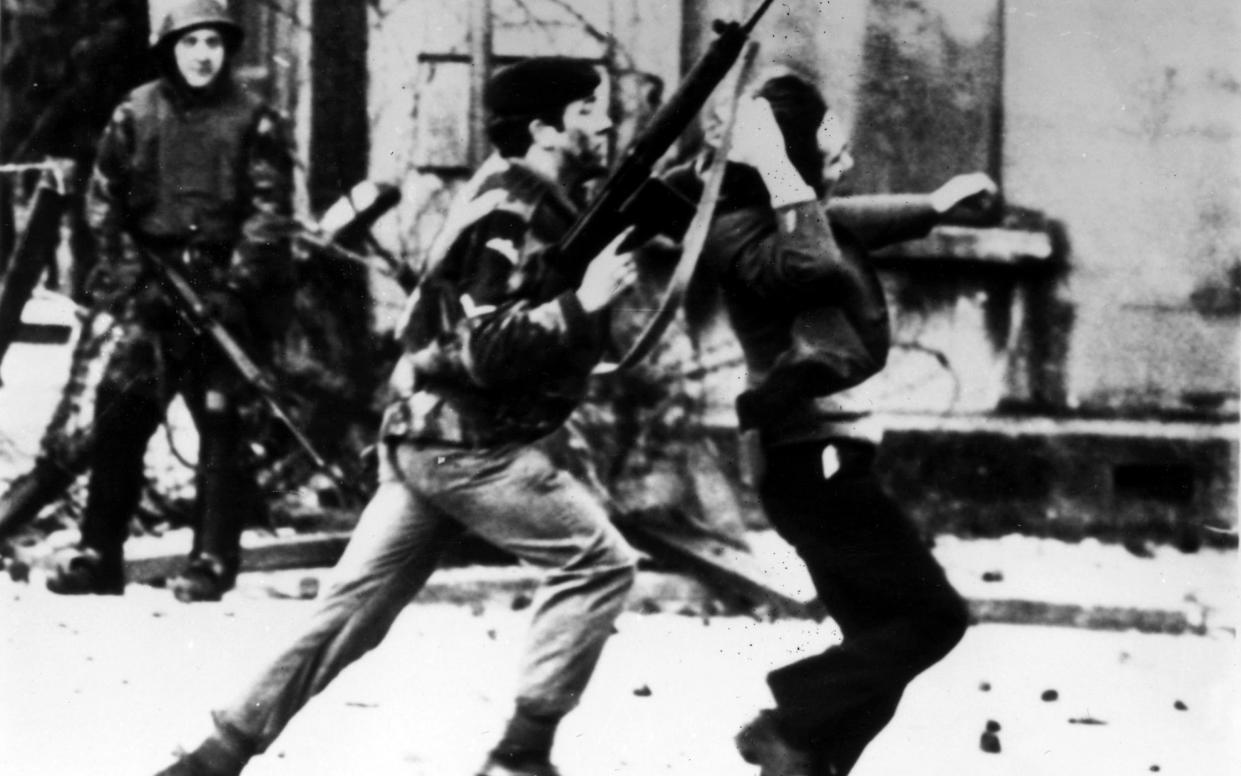 A British paratrooper apprehends a young person on Bloody Sunday