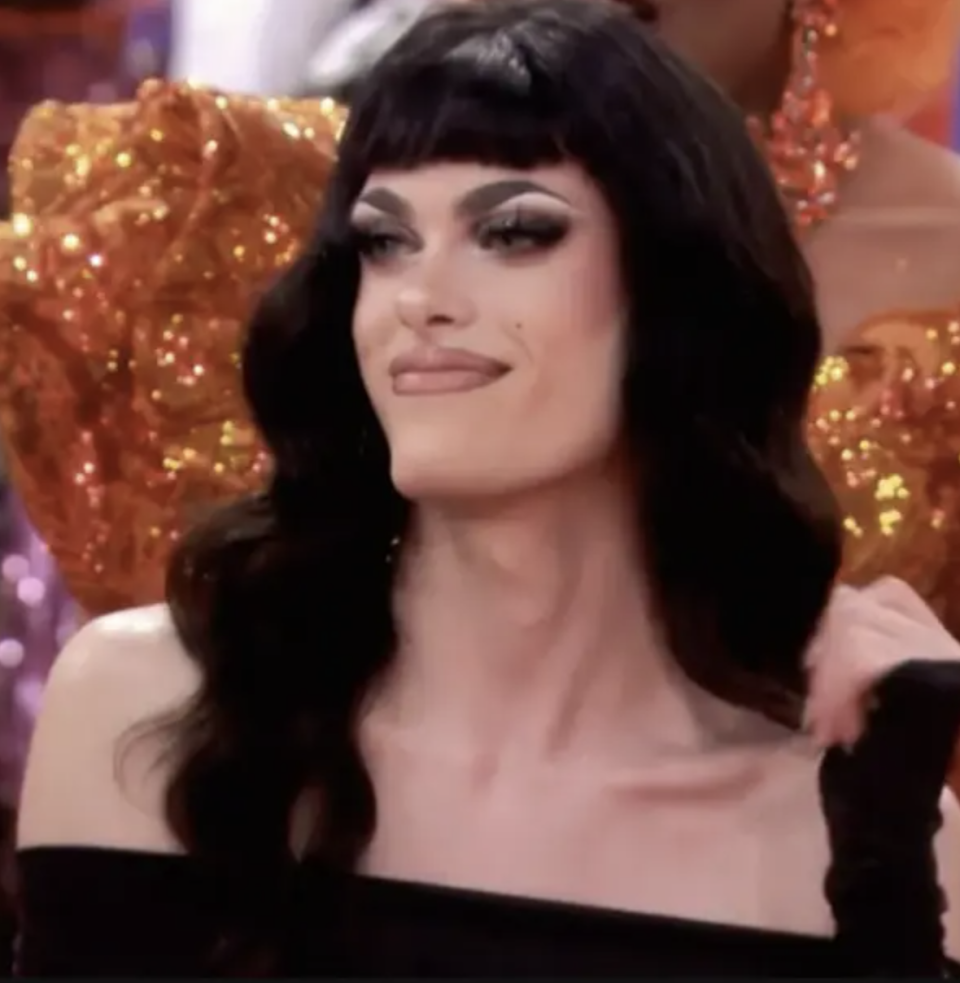 A queen from "Drag Race" looking proud