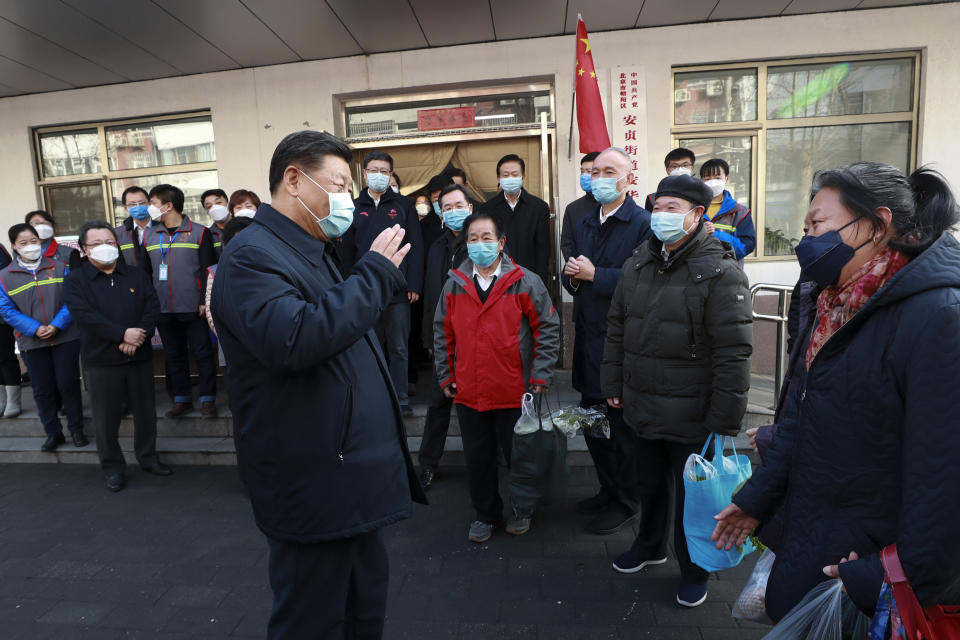 Xi Jinping wearing a protective face mask while speaking to residents in Beijing. Source: AP