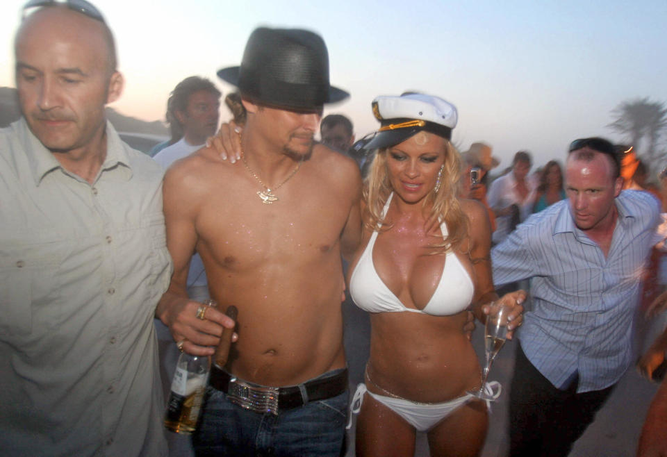 A photo of Canadian actress Pamela Anderson wearing a white bikini with her shirtless husband, US musician Kid Rock, on the day of their wedding on Pampelone's beach in Saint-Tropez, Southern France, 29 July 2006.