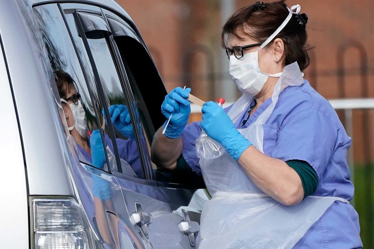 A member of the public is swabbed at a drive-through coronavirus testing site in Wolverhampton: Getty Images