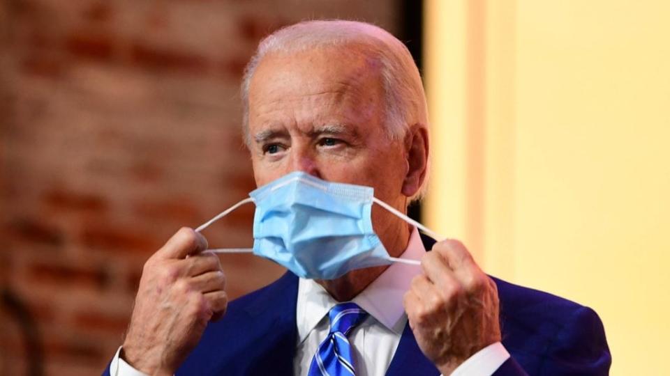 President-elect Joe Biden removes his face mask before delivering a Thanksgiving address at the Queen Theatre on Nov. 25 in Wilmington, Delaware. (Photo by Mark Makela/Getty Images)