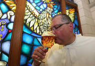 Norbertine Father Karel tastes a Grimbergen beer, symbolised by a phoenix, in the courtyard of the Belgian Abbey of Grimbergen before announcing that the monks will return to brewing after a break of two centuries, in Grimbergen, Belgium May 21, 2019. REUTERS/Yves Herman