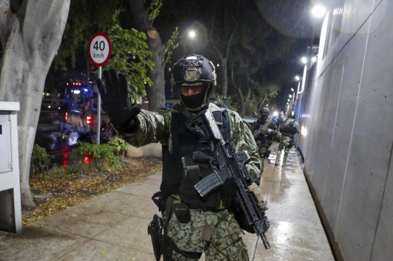 Mexican law enforcement members stand guard during the arrest of Nestor Isidro Perez Salas in Culiacan, Sinaloa, Mexico, on Nov. 23. File Photo by Isaac Esquivel/EPA-EFE