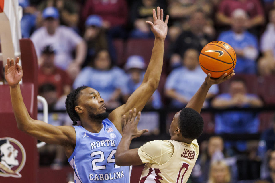 Florida State guard Chandler Jackson (0) tries to shoot around North Carolina forward Jae'Lyn Withers (24) during the second half of an NCAA college basketball game, Saturday, Jan. 27, 2024, in Tallahassee, Fla. North Carolina defeated Florida State 75-68. (AP Photo/Colin Hackley)