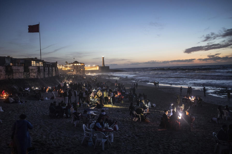 People break their Ramadan fast by the beach in Rabat, Morocco, Saturday, April 23, 2022. For the first time in two years since the COVID-19 pandemic, people were able to revive a Ramadan tradition of gathering and breaking their fast in public. (AP Photo/Mosa'ab Elshamy)