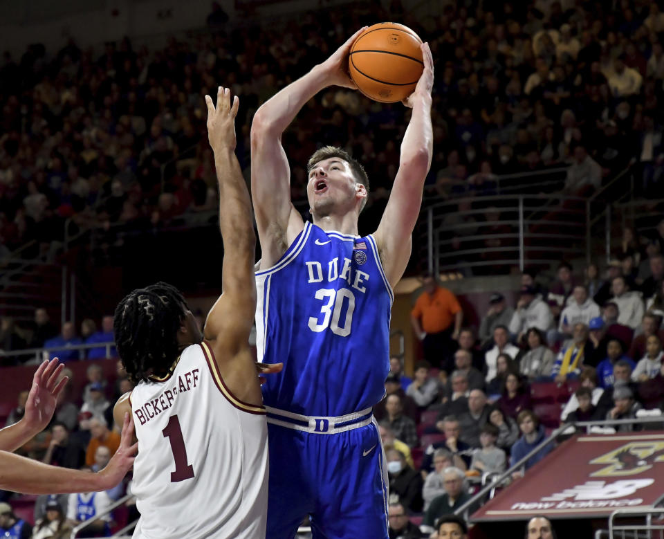 Duke's Kyle Filipowski (30) attempts a basket over Boston College's T.J. Bickerstaff (1) during the first half of an NCAA college basketball game, Saturday, Jan. 7, 2023, in Boston. (AP Photo/Mark Stockwell)