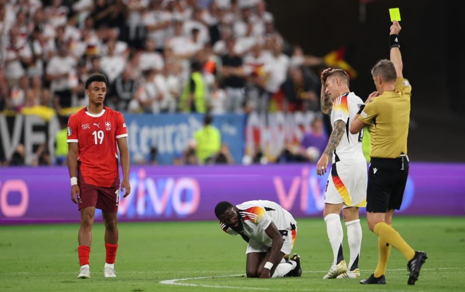 Dan Ndoye is shown a yellow card