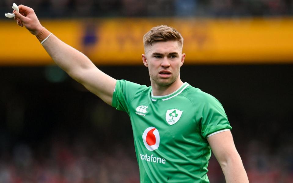 Jack Crowley of Ireland raises his arm with his mouthguard in his hand during the Six Nations match against Wales