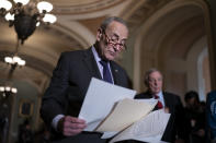 Senate Majority Leader Chuck Schumer, D-N.Y., joined at right by Majority Whip Dick Durbin, D-Ill., looks over his notes as he prepares to speak to reporters after a Democratic policy meeting at the Capitol in Washington, Tuesday, Nov. 2, 2021. (AP Photo/J. Scott Applewhite)
