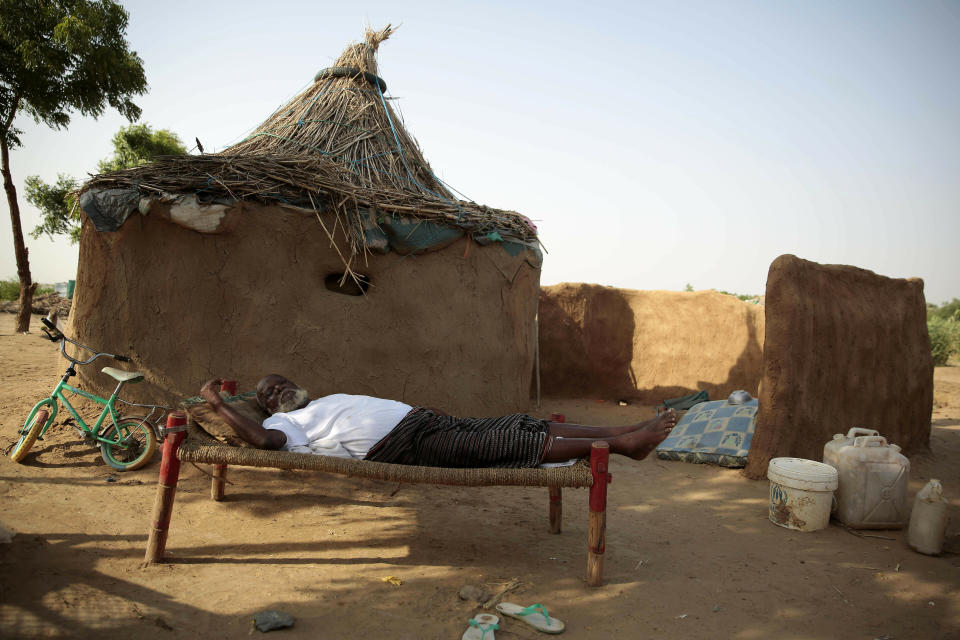 FILE - In this Oct. 7, 2016 file photo, a man rests on a bed in front of his hut at a camp for internally displaced people near the town of Abs, in the Hajjah governorate, of Yemen. The U.N. Office for the Coordination of Humanitarian Affairs, or OCHAU.N. warned in a report Tuesday, March 12, 2019, that thousands of Yemeni civilians caught in fierce clashes between warring factions are trapped in the embattled northern district of Hajjah. The number of displaced in the district has doubled over the past six months, the humanitarian agency said. (AP Photos Hani Mohammed, File)