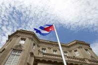 The Cuban national flag is seen raised over their new embassy in Washington, July 20, 2015. The Cuban flag was raised over Havanaâ€™s embassy in Washington on Monday for the first time in 54 years as the United States and Cuba formally restored relations, opening a new chapter of engagement between the former Cold War foes. REUTERS/Andrew Harnik/Pool