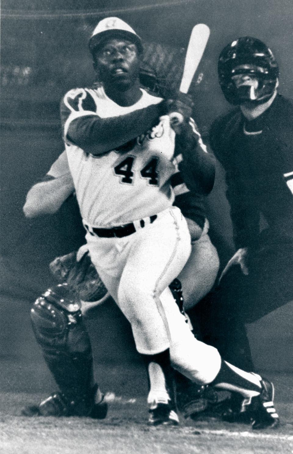 Hank Aaron, Atlanta Braves slugger, eyes the flight of the ball after hitting his 715th home run to break Babe Ruth's all-time home run record in April 1974.