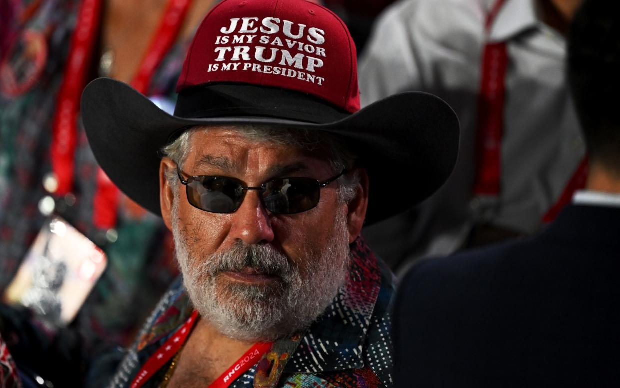 A man wears a cowboy hat that reads "Jesus is my savior, Trump is my president" on the first day of the Republican National Convention at the Fiserv Forum on July 15, 2024 in Milwaukee