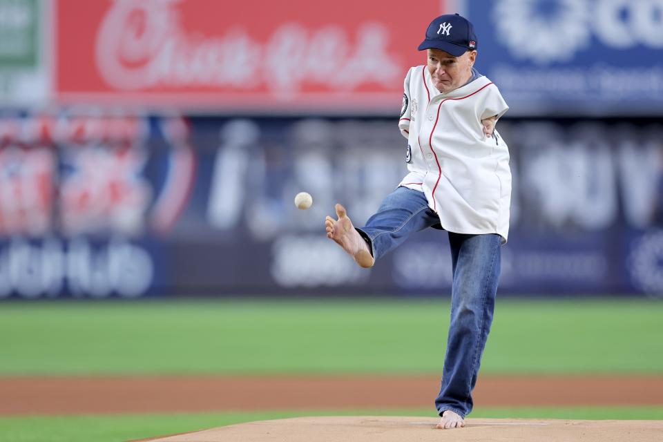 MLB fan Tom Willis throws out a ceremonial first pitch with his foot before a game between the New York Yankees and the Toronto Blue Jays at Yankee Stadium.