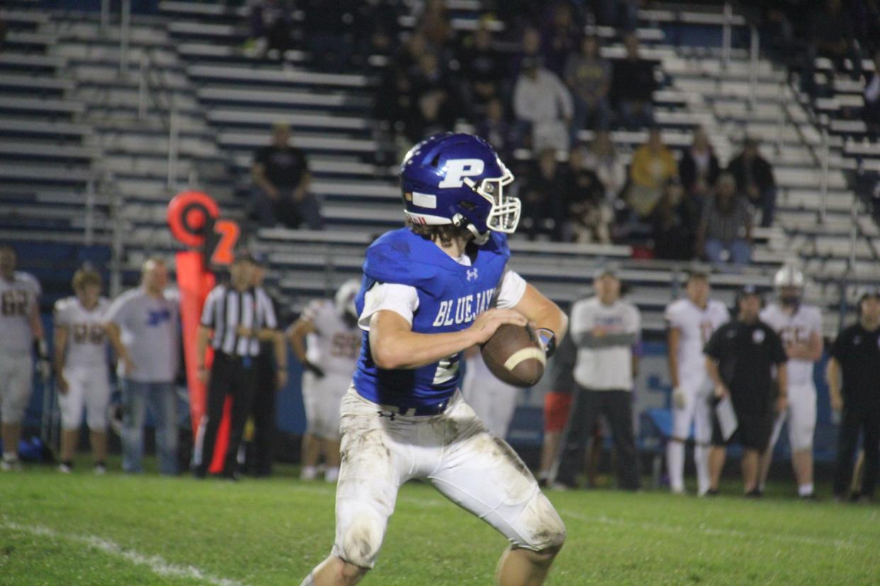 Perry's Geren Kenney looks to throw a pass on Friday, Sept. 22, 2023, at Dewey Field in Perry.