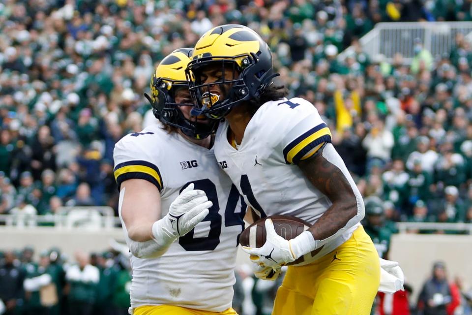 Michigan Wolverines receiver Andrel Anthony (1) celebrates with tight end Joel Honigford after making his touchdown catch of the game, during the second quarter against the Michigan State Spartans at Spartan Stadium, Oct. 30, 2021 in East Lansing.