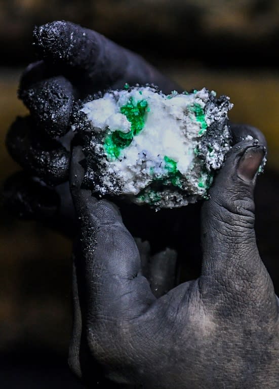 Sometimes guaqueros find sparkling green stones in a wash of shale, as a geologist shows here