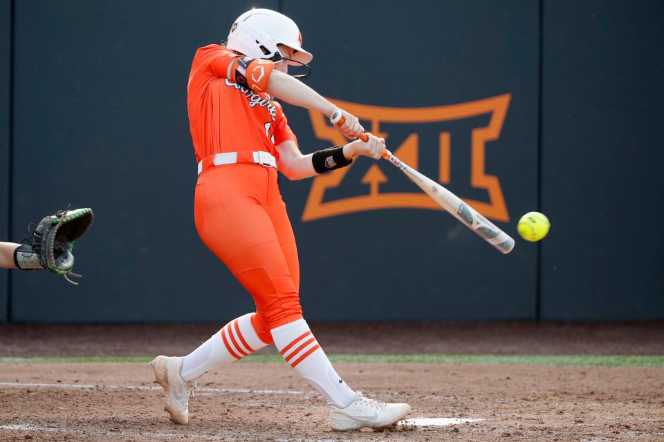 Oklahoma State's Rachel Becker (15) drives in two runs in the fifth inning of the second game between the Oklahoma State Cowgirls (OSU) and the Oregon Ducks in the Stillwater Super Regional of the NCAA softball tournament in Stillwater, Okla., Friday, May 26, 2023. Oklahoma State won 9-0.