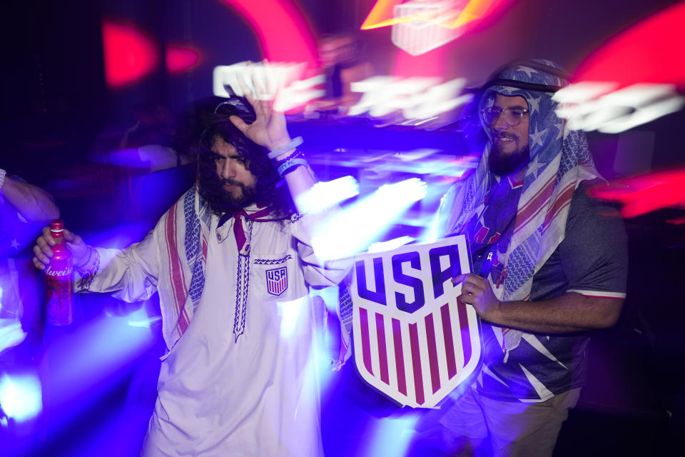 People dance during an official U.S. Soccer fan party at the Budweiser World Club ahead of a FIFA World Cup group B soccer match between the United States and Wales, in Doha, Sunday, Nov. 20, 2022. (AP Photo/Ashley Landis)