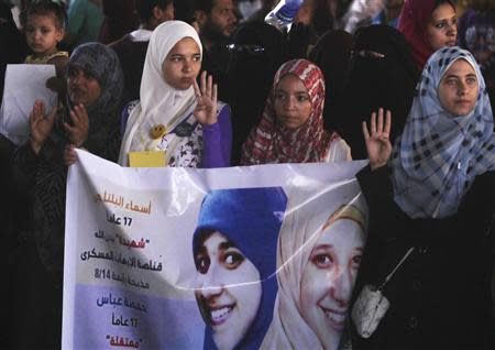 Members of the Muslim Brotherhood and supporters of ousted Egyptian President Mohamed Mursi rally against the military and interior ministry, as they show the "Rabaa" or "four" gesture, in reference to the police clearing of Rabaa al-Adawiya protest camp on August 14, in the southern suburb of Maadi September 3, 2013. REUTERS/Amr Abdallah Dalsh