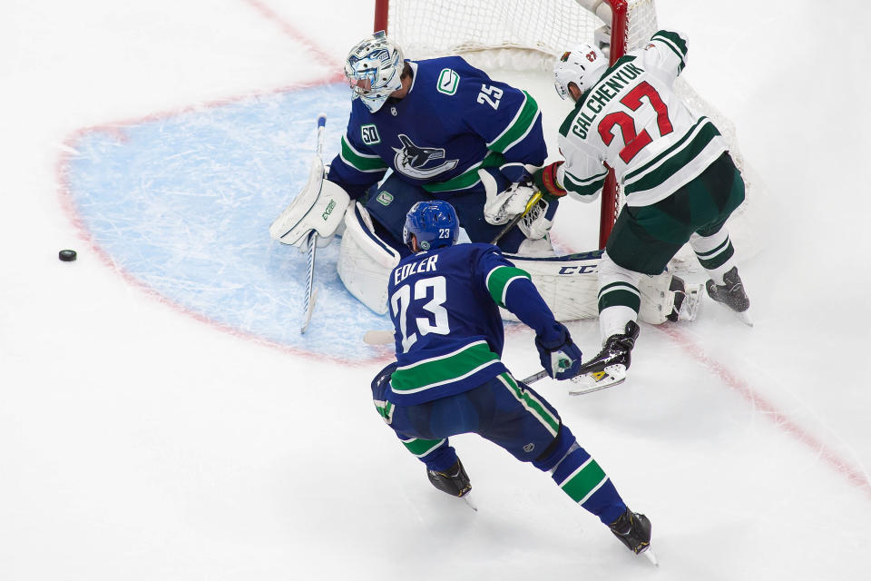 Vancouver Canucks goaltender Jacob Markstrom (25) makes a save against Minnesota Wild's Alex Galchenyuk (27) during the third period of an NHL hockey playoff game Sunday, Aug. 2, 2020, in Edmonton, Alberta. (Codie McLachlan/The Canadian Press via AP)