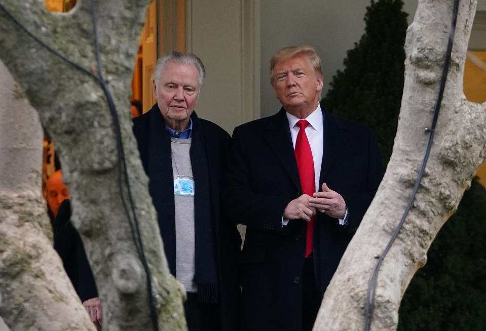 US President Donald Trump (R) stands with actor Jon Voight outside the Oval Office before departing from the South Lawn of the White House in Washington, DC on January 28, 2020