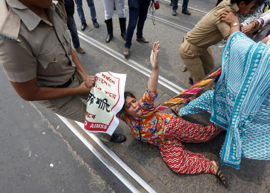 <p>Police detain an activist of the Socialist Unity Centre of India (SUCI) during a protest against the recent gang-rape of a woman in a moving car, according to local media, in Kolkata, India, May 31, 2016. (Reuters/Rupak De Chowdhuri) </p>