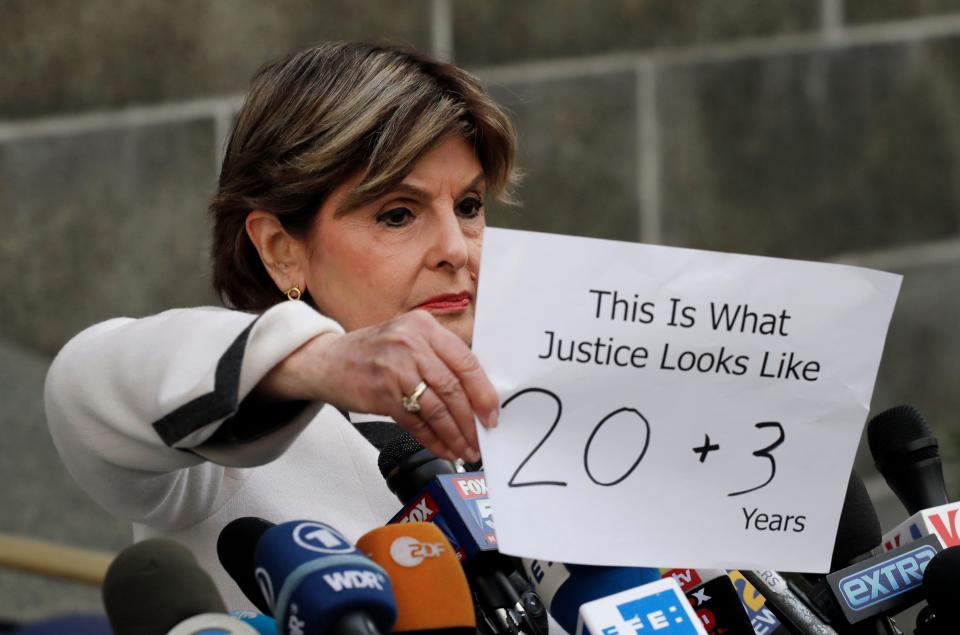 Attorney Gloria Allred holds a sign up to reporters outside the courthouse after Harvey Weinstein's sentencing on March 11, 2020, in New York.