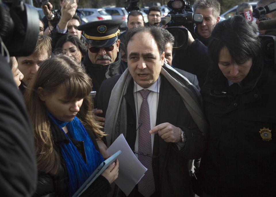 Monzer Akbik, center, a Syrian opposition spokesman, is surrounded by journalists after a short press briefing at the United Nations headquarters in Geneva, Switzerland, Switzerland, Monday, Jan. 27, 2014. Akbik said the coalition was still determined to stay for the political talks set to begin Monday despite accusing the government of stalling. (AP Photo/Anja Niedringhaus)