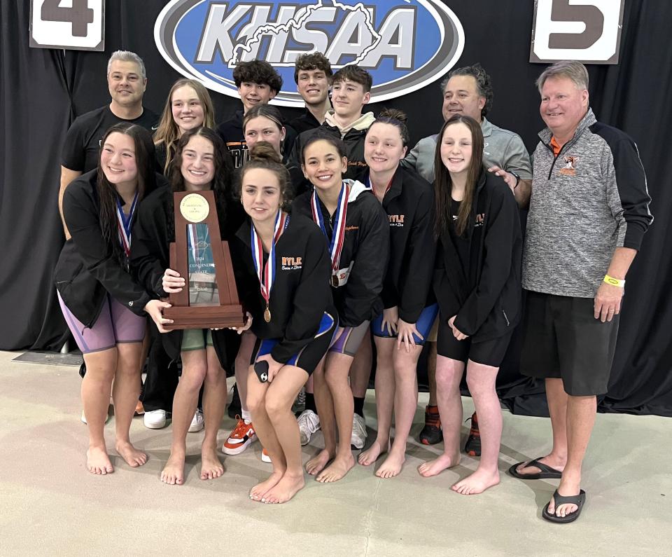 Ryle boys and girls swimmers and coaches pose with their combined team championship trophy during the KHSAA state girls swimming championships Feb. 24, 2024 at the University of Kentucky's Lancaster Aquatic Center.