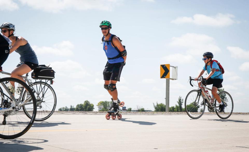 A man on roller blades joins a group of cyclists as they head east along the route during RAGBRAI in 2017.