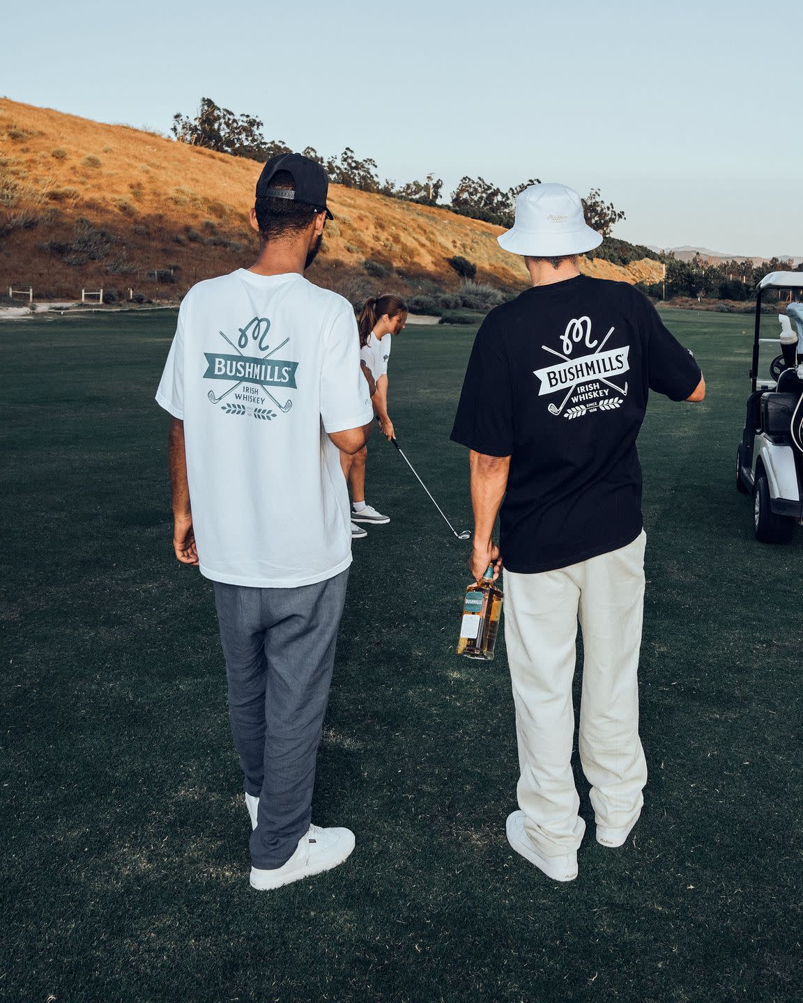 a couple of men standing on a golf course