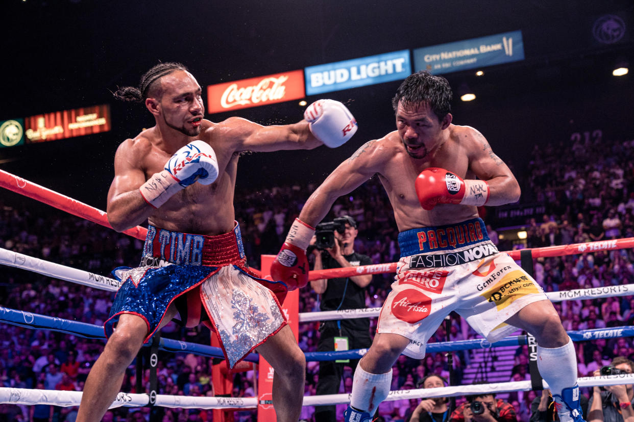  Keith Thurman (L) versus Manny Pacquiao in 2019 fight . 
