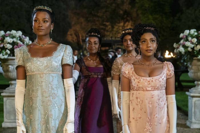 Simone Ashley in a gown and long gloves alongside her sisters in a still from Bridgerton