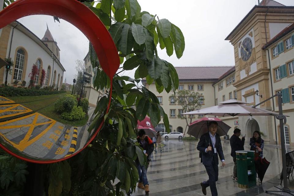 People walk in the Huawei's Ox Horn campus