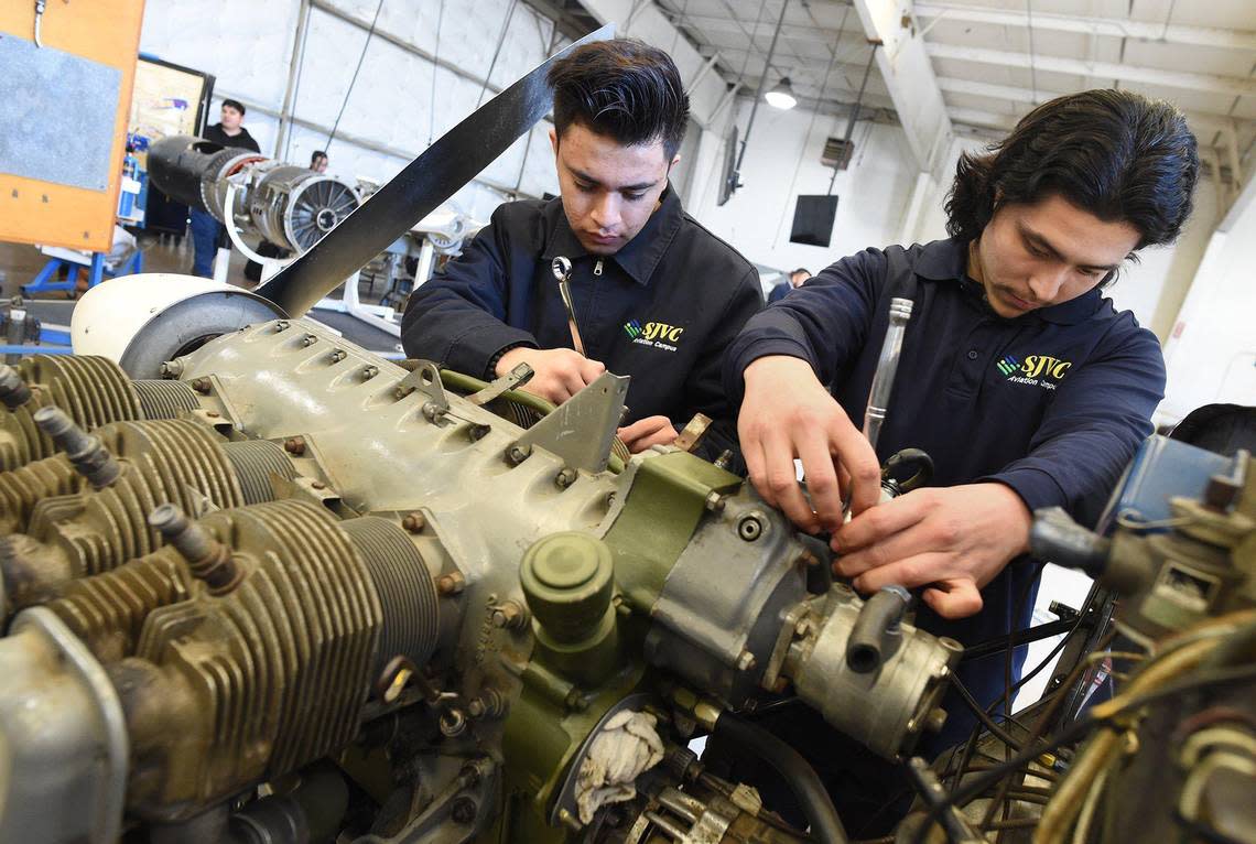 San Joaquin Valley College aviation maintenance technology students Jovany Martinez, left, and Rosendo Marquez work a on a airplane engine during class on March 9, 2022. SkyWest Airlines is partnering with SJVC for a scholarship and apprenticeship program to hire graduates of the school’s program.