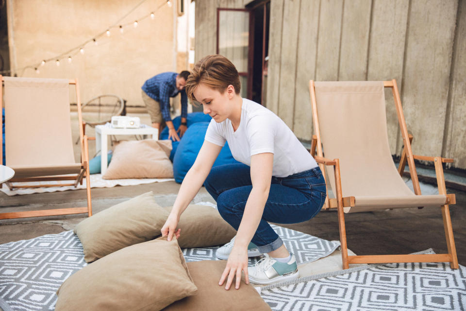 woman checking outdoor cushion covers