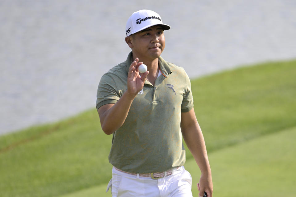 Kurt Kitayama acknowledges the crowd after making a birdie putt on the 18th green during the first round of the Arnold Palmer Invitational golf tournament, Thursday, March 2, 2023, in Orlando, Fla. (AP Photo/Phelan M. Ebenhack)