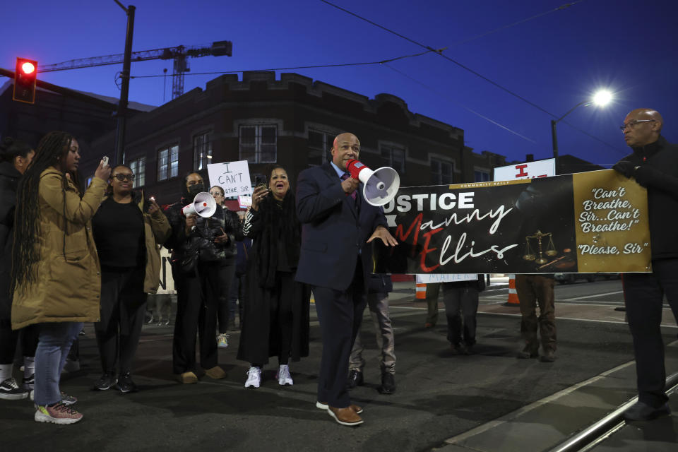 Attorney James Bible, center, who represented the Ellis family in a civil lawsuit, speaks to a crowd at a rally after the verdict was read at the trial of three Tacoma Police officers in the killing of Manny Ellis, at Pierce County Superior Court, Thursday, Dec. 21, 2023, in Tacoma, Wash. (AP Photo/Maddy Grassy)