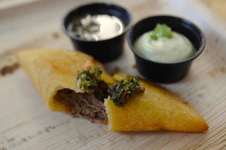A shredded beef empanada with chimichurri sauce is served at Rava's Venezuelan food on Saturday, April 6, 2024.