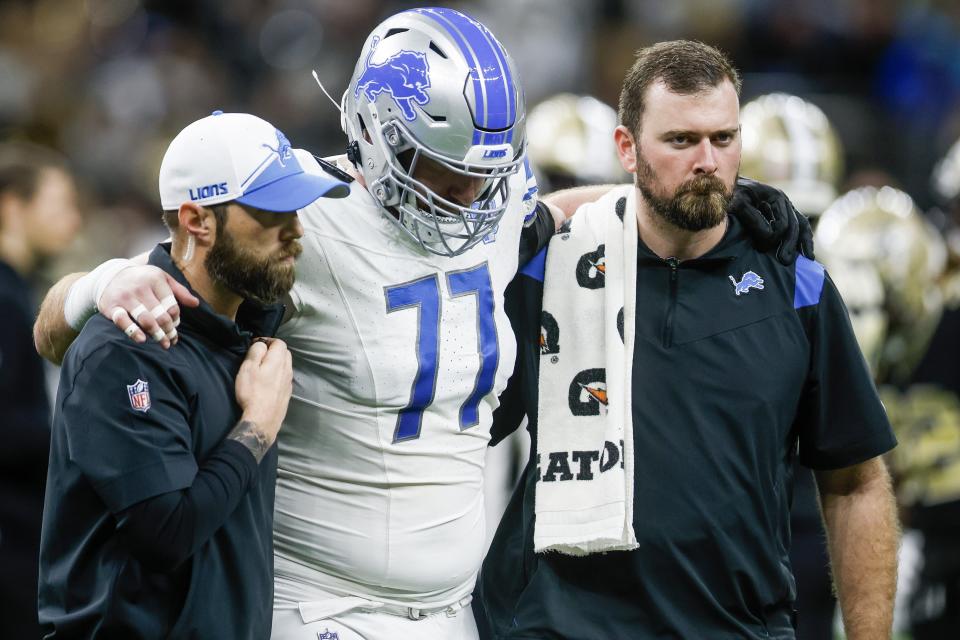 Lions center Frank Ragnow is helped off the field after suffering a knee injury in the first quarter of the Lions' 33-28 win over the Saints on Sunday, Dec. 3, 2023, in New Orleans.