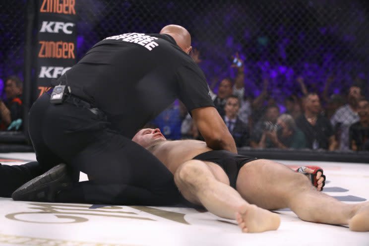 Referee Dan Miragliotta tends to Fedor Emelianenko after the Russian was stopped by Matt Mitrione in the first round Saturday at Madison Square Garden. (The Associated Press)