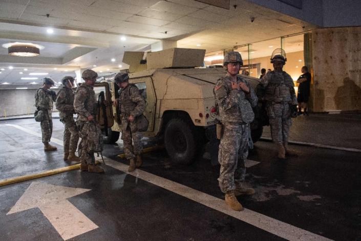 North Carolina's governor has declared a state of emergency in Charlotte, and several hundred National Guard troops were deployed to reinforce local police (AFP Photo/Nicholas Kamm)