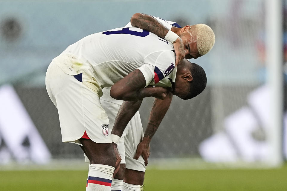 Haji Wright of the United States is comforted after losing the World Cup round of 16 soccer match between the Netherlands and the United States, at the Khalifa International Stadium in Doha, Qatar, Saturday, Dec. 3, 2022. (AP Photo/Martin Meissner)