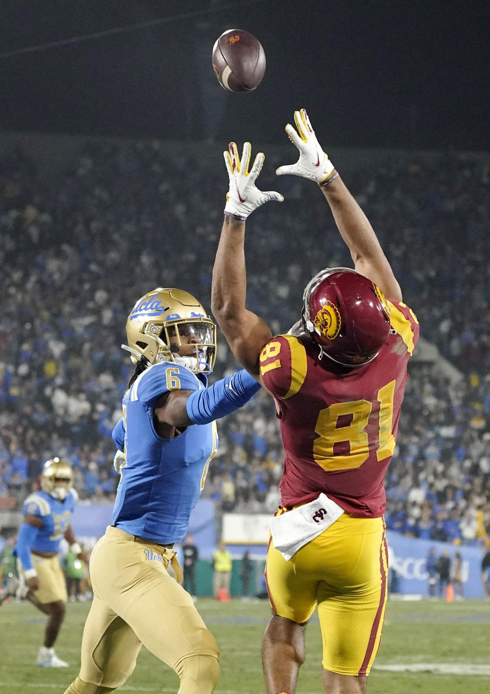Southern California wide receiver Kyle Ford, right, catches a touchdown pass as UCLA defensive back John Humphrey defends during the second half of an NCAA college football game Saturday, Nov. 19, 2022, in Pasadena, Calif. (AP Photo/Mark J. Terrill)